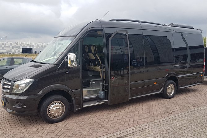 1-15pers Taxi/Bus Transfer Amsterdam Airport to Rotterdam Airport - Pickup at Schiphol: meeting point near Burger King