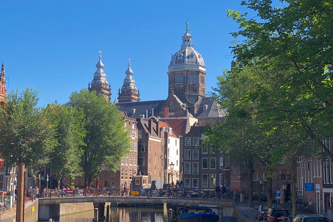 Absolutely Amsterdam - the Essential Introductory Walking Tour - Damrak: Red Light District Origins and the Shifting Line Between Holy and Profane