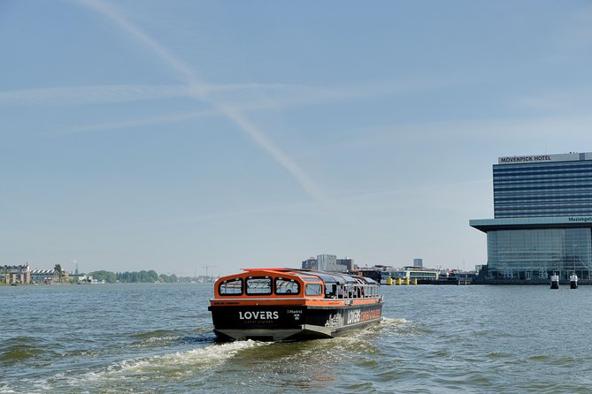 Amsterdam 1h Canal Cruise by Semi-Open Boat with Audio Guide - Munt Tower and Singel Canal: how you spot the medieval city