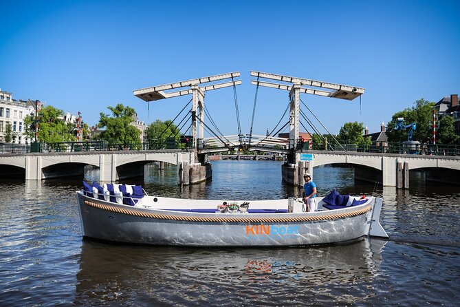 Amsterdam Canal Cruise in Open Boat with Unlimited Drinks Option - Hermitage Museum glide and the UNESCO canal loop