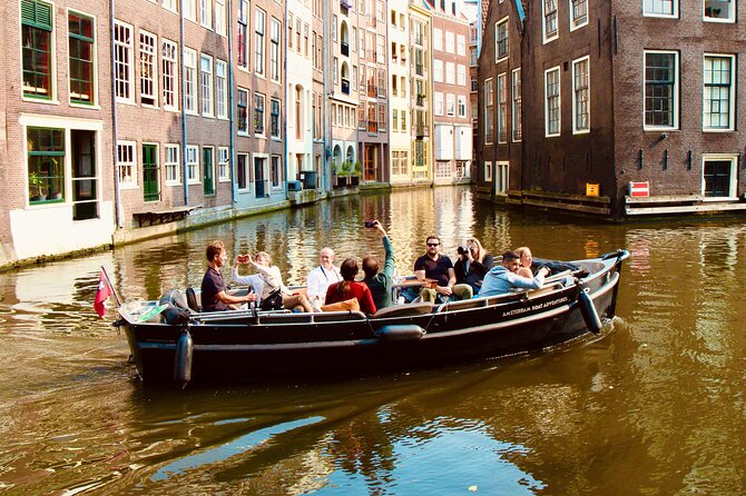 Amsterdam Canal Tour by Open Boat – 90 min Small Group Experience - Into the De Wallen edge: Munt Tower, Zuiderkerk, and the red-light border