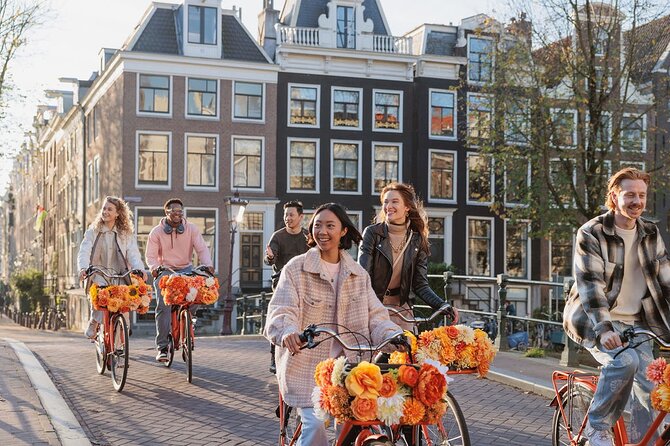 Amsterdam City Top Highlights Guided Bike Tour - Riding past the Red Light District and central squares with context