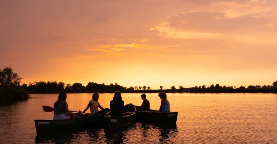 Amsterdam: Dutch Countryside Sunset Canoe Tour - Pre-canoe village drink, safety briefing, and wet-feet reality