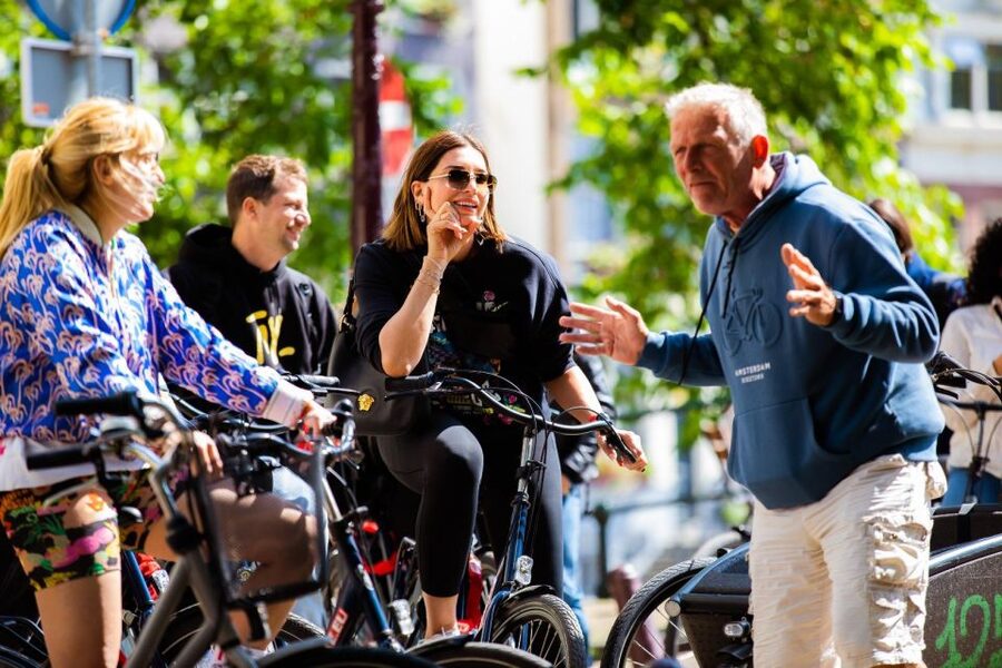 Amsterdam: Explore the City Highlights by Bike - Anne Frank House exterior and Westerkerk views, plus how the guide manages the group