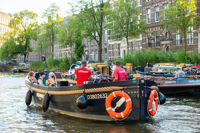 Amsterdam: Guided Open Boat Canal Cruise Unlimited Drinks Option - Bridges, Markets, and the City’s Everyday Personality