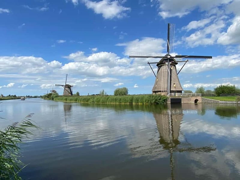 Amsterdam: Kinderdijk, Euromast, Delft and Den Haag Day Tour - Delft on Foot: Canals, Gables, and Medieval Towers Without the Stampede