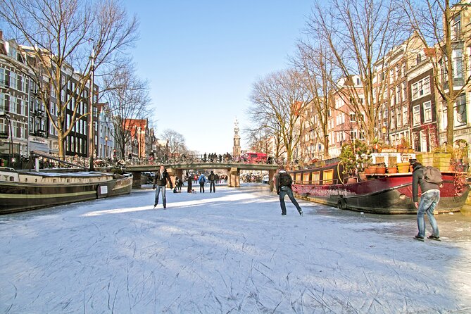 Amsterdam Light Festival Winter Walk with Stroopwafel Workshop - Dam Square and the Royal Palace, where your guide sets the tone