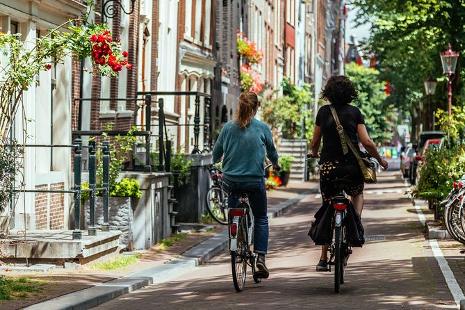 Amsterdam PRIVATE Bike Tour With Locals: Bike & Local Snack Included - Stop 3: Cycling through canals, alleyways, and Jordaan energy