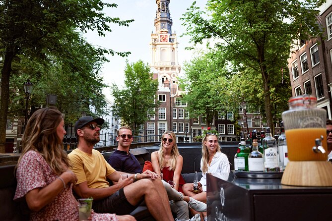Amsterdam Private Boat Trip with Pizza and Unlimited Drinks - What to expect onboard: the skipper, the pace, and photo-friendly moments