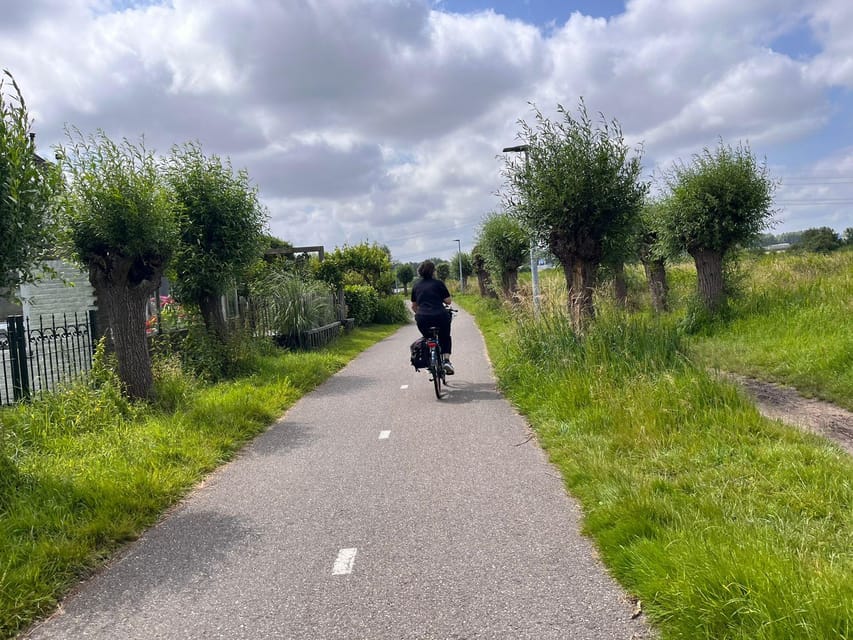 Amsterdam: Rainbow Rural Bike Tour With Local Gay Guide - Dyke views and the daily math of living with water