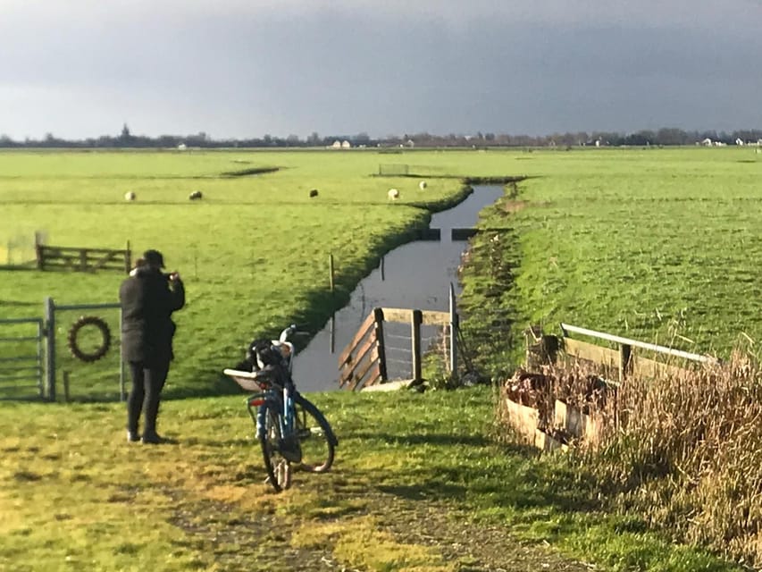 Amsterdam: Rainbow Rural Bike Tour With Local Gay Guide - Old wooden houses, green space, and North Amsterdam’s quieter rhythm