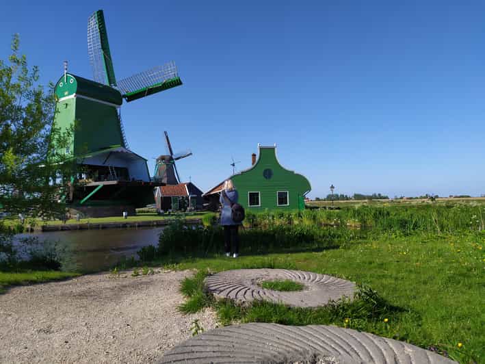 Amsterdam: Rainbow Rural Bike Tour With Local Gay Guide - The abandoned industrial harbor and murals that change the mood
