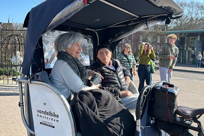Explore Amsterdam in 75 Minutes – Pedicab Rickshaw City tour - Dam Square: the city’s main stage, seen from the right angle