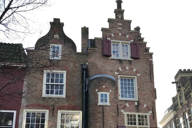 Famous Holland Tour: visit The Hague, Delft, Rotterdam and Kinderdijk from A'dam - Stop 2: Delft canals, gables, and towers in a smaller-town mood